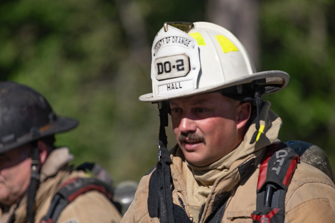 firefighter-wearing-a-white-helmet-and-protective-gear-qhlxnidshkw
